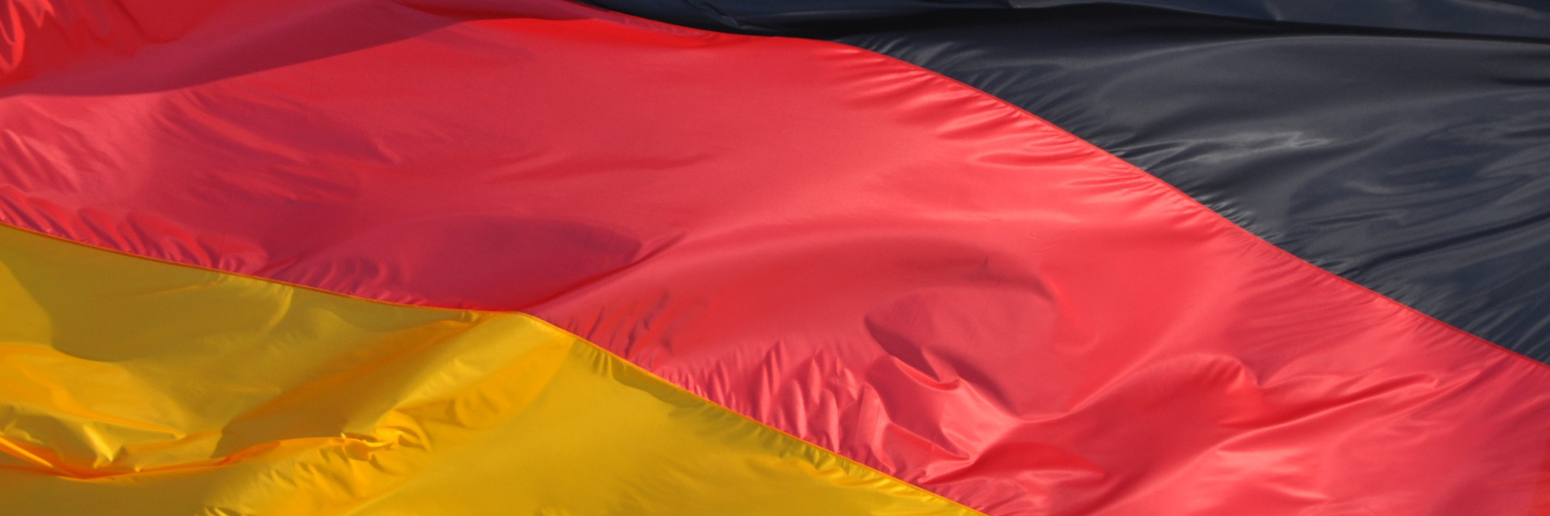 Close-up image of black, red, and yellow German flag.