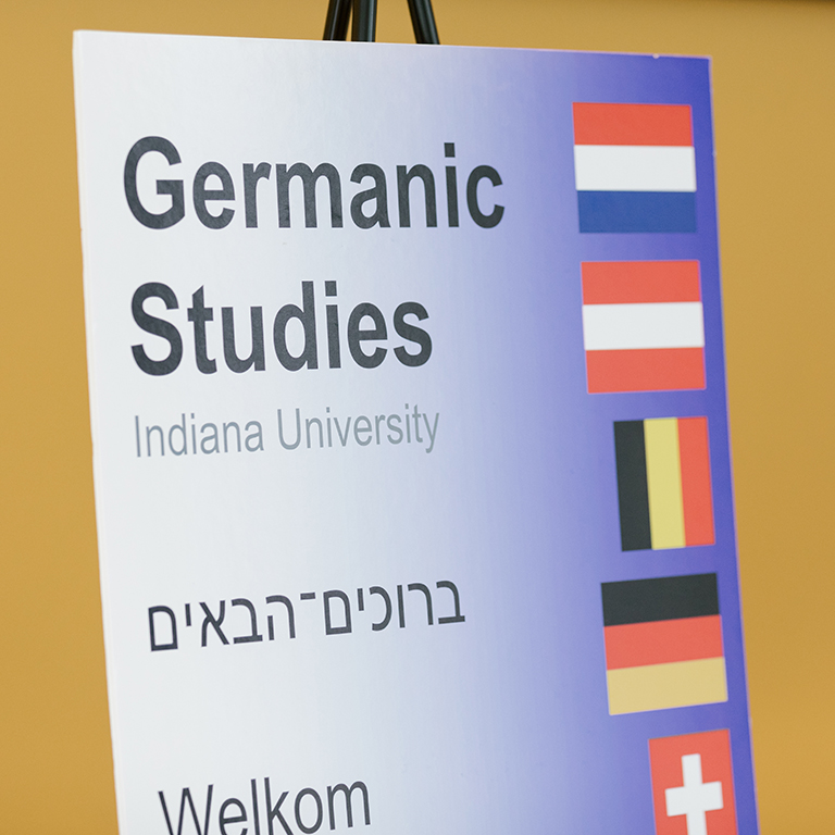 A Germanic Studies sign reading welcome in multiple languages.
