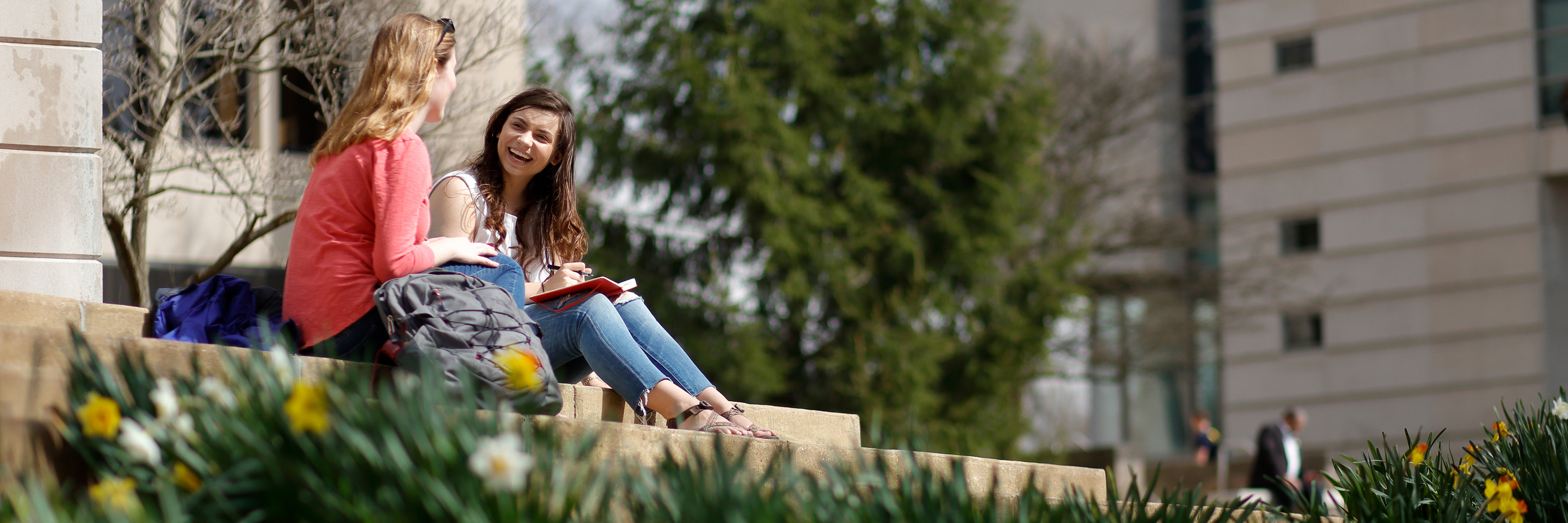 Students sit outside on the scenic Indiana University Bloomington campus.  