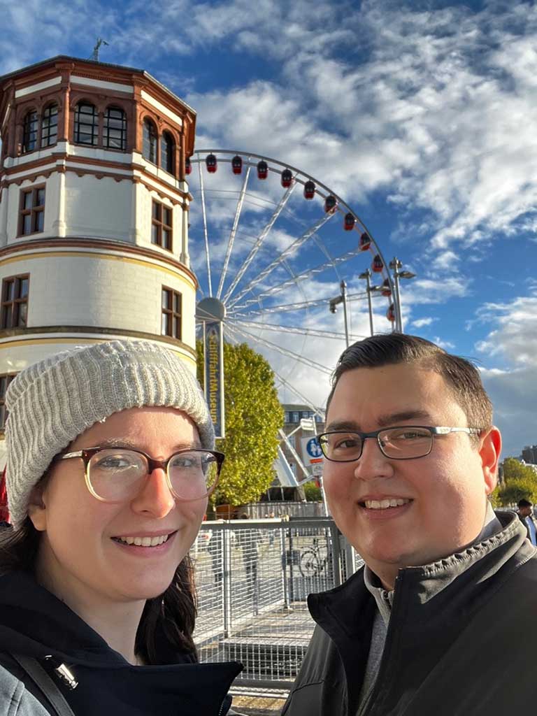 Antonio Garcia poses with his girlfriend with a Ferris wheel in the background.