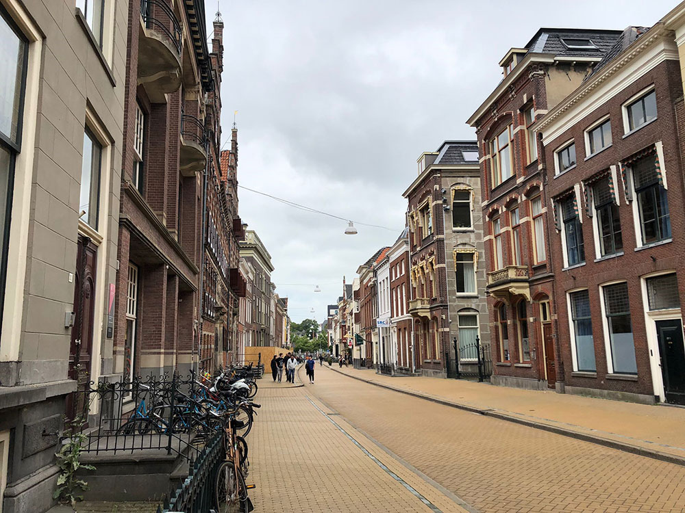 A street view featuring historic buildings and parked bicycles